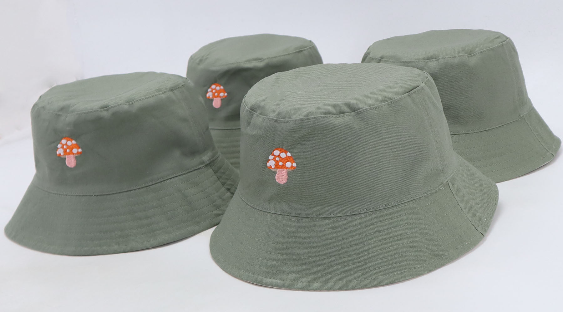 Green bucket hats with mushroom embroidery
