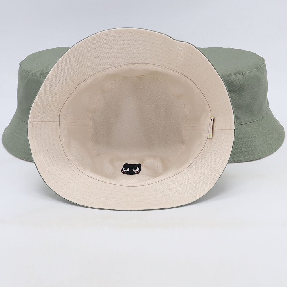 White cat bucket hat with green exterior and cat face detail