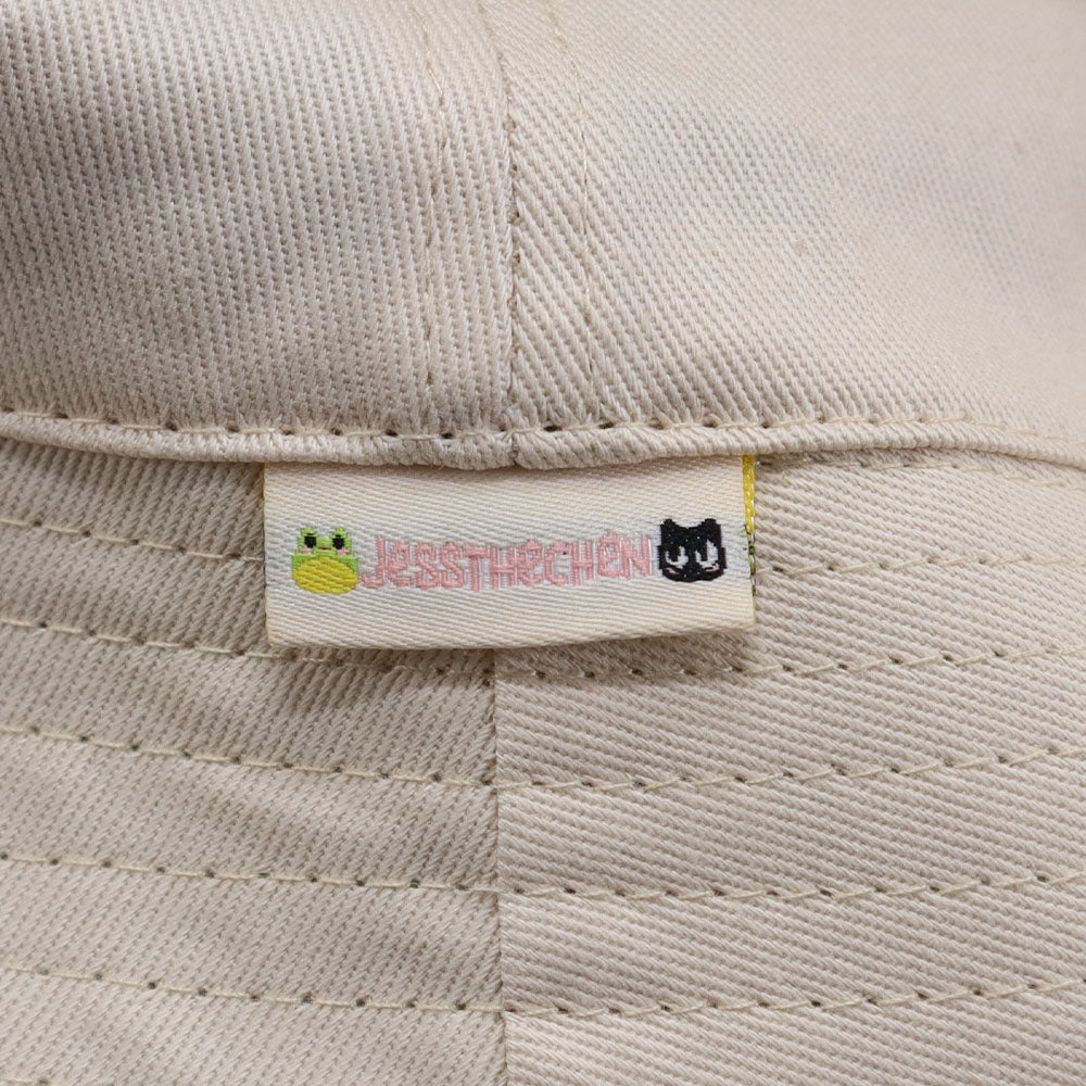 White cat bucket hat with JessyTirschen tag