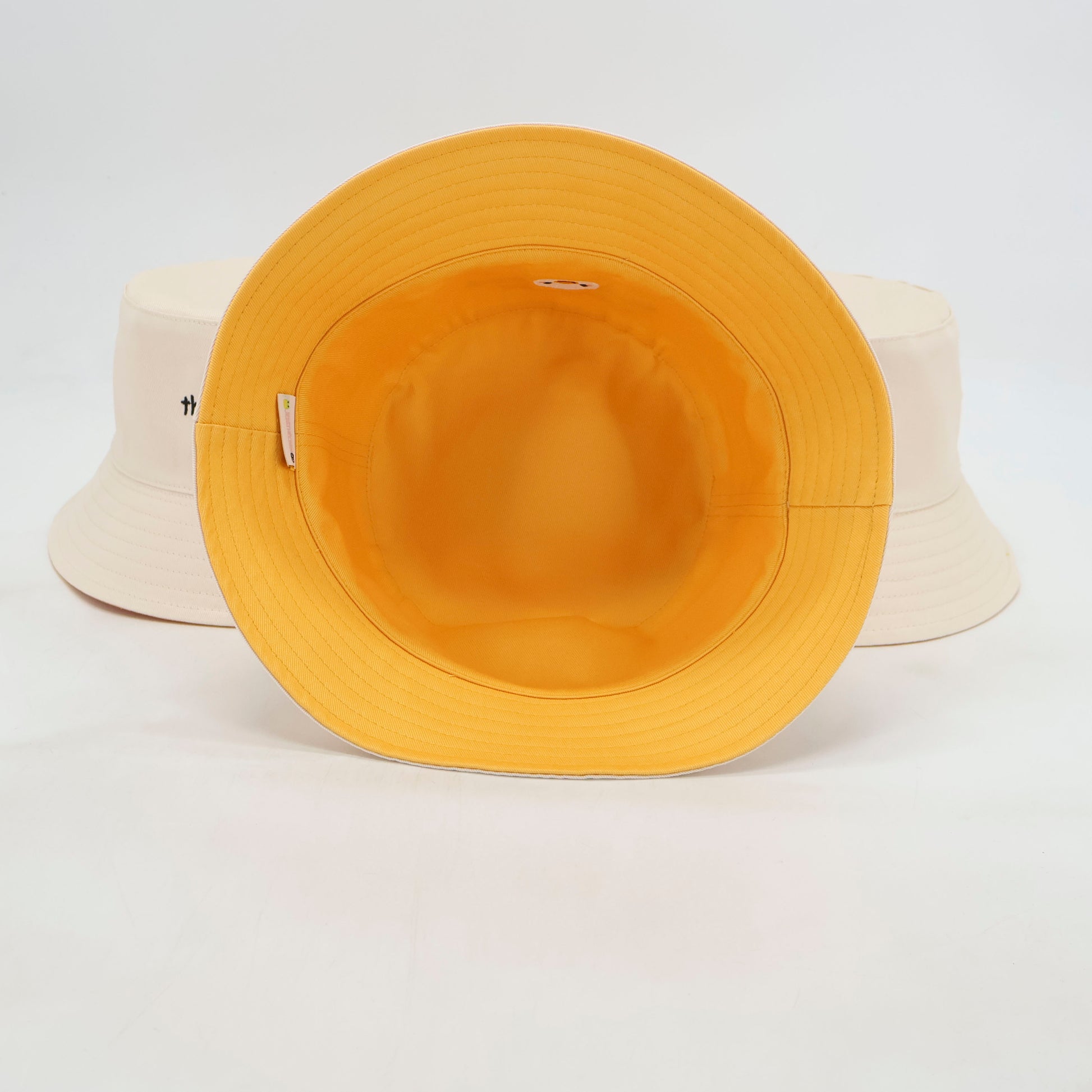 White duck bucket hat, yellow interior