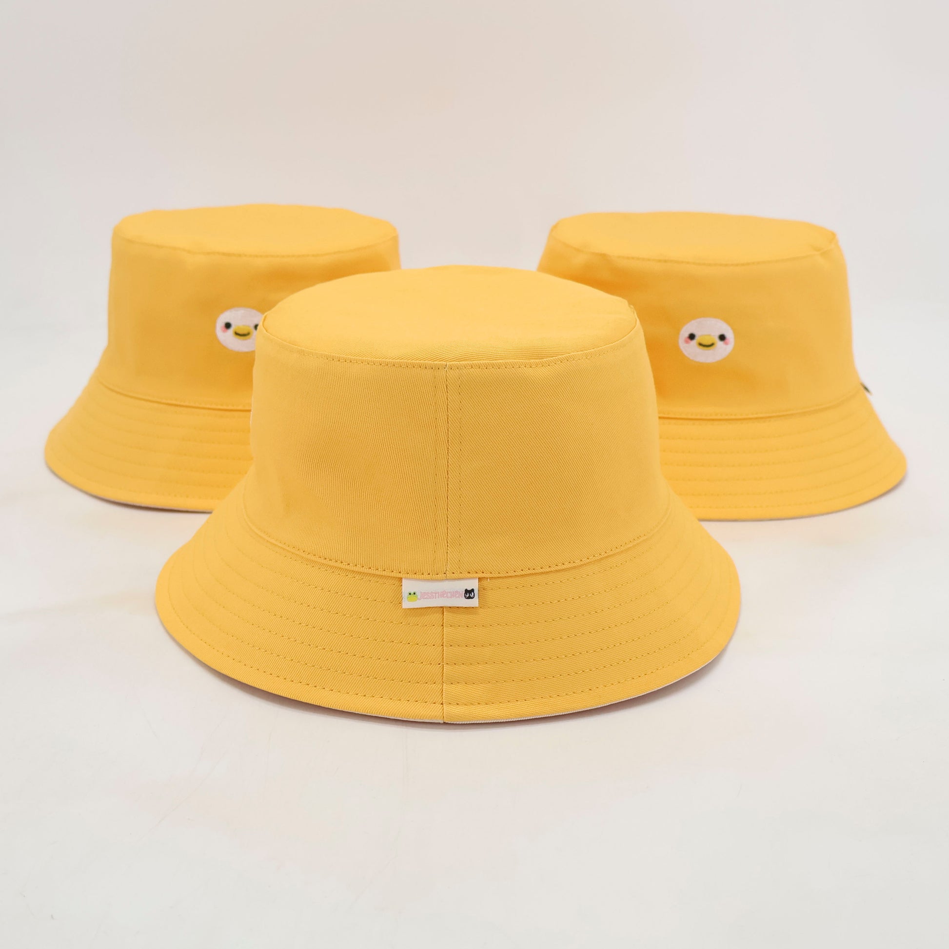 Yellow bucket hats with duck embroidery