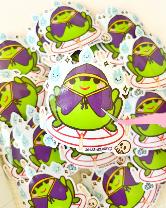 Die-cut Summon frog stickers being glued