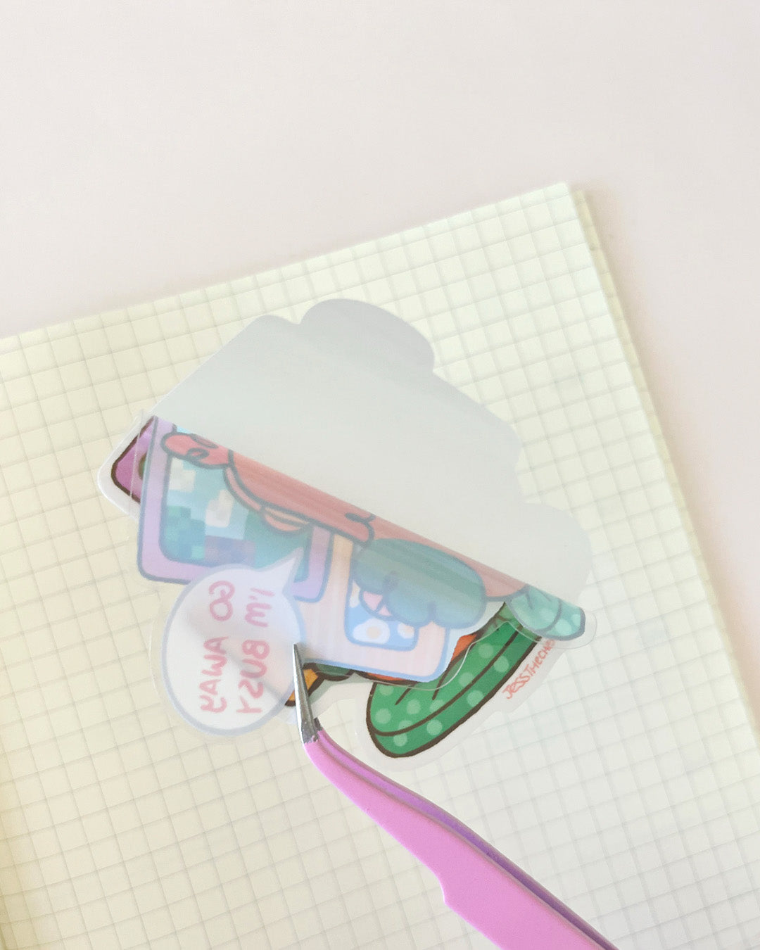Die-cut Macy Go Away sticker being peeled from paper
