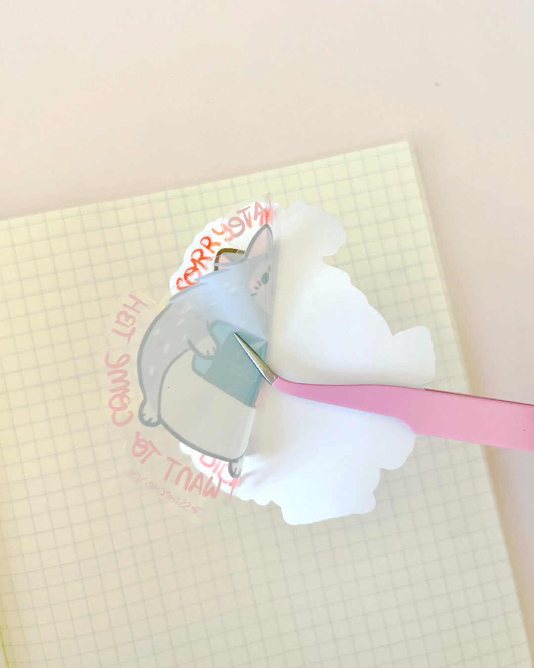 Die-cut sticker of a cat being peeled from backing, Trent Didn't Wanna
