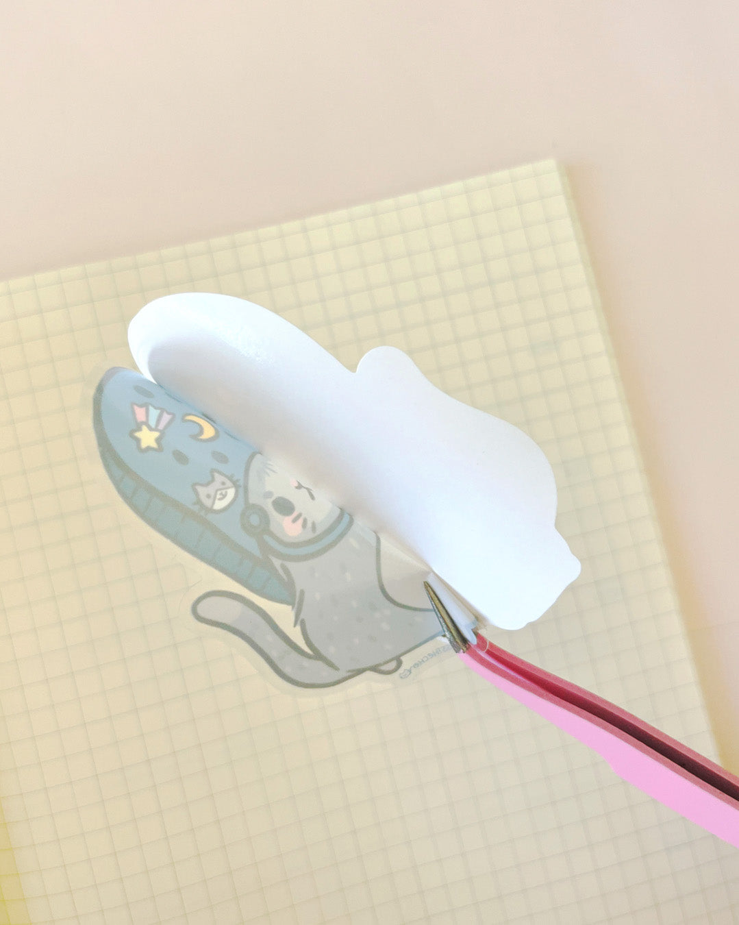 Die-cut astronaut cat sticker being peeled - Trent 4