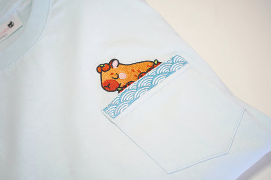 Light blue tee with pocket and cartoon design