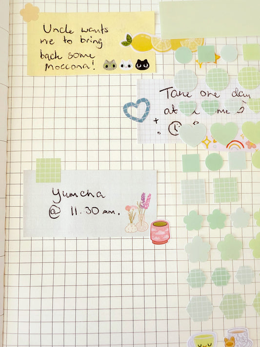 Green stickers and notes on grid paper, including Yumcha and Moccona
